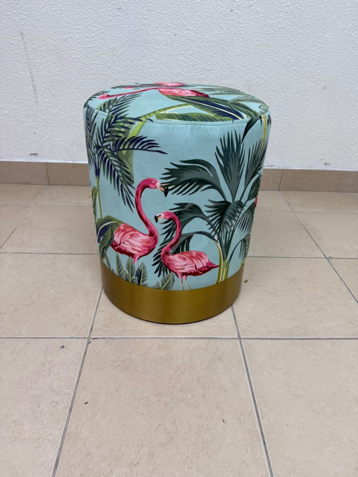 The ottoman from Home Centre features a tropical pattern depicting flamingos.