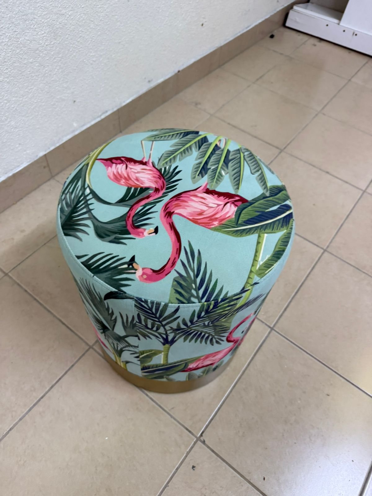The ottoman from Home Centre features a tropical pattern depicting flamingos. - Image 3