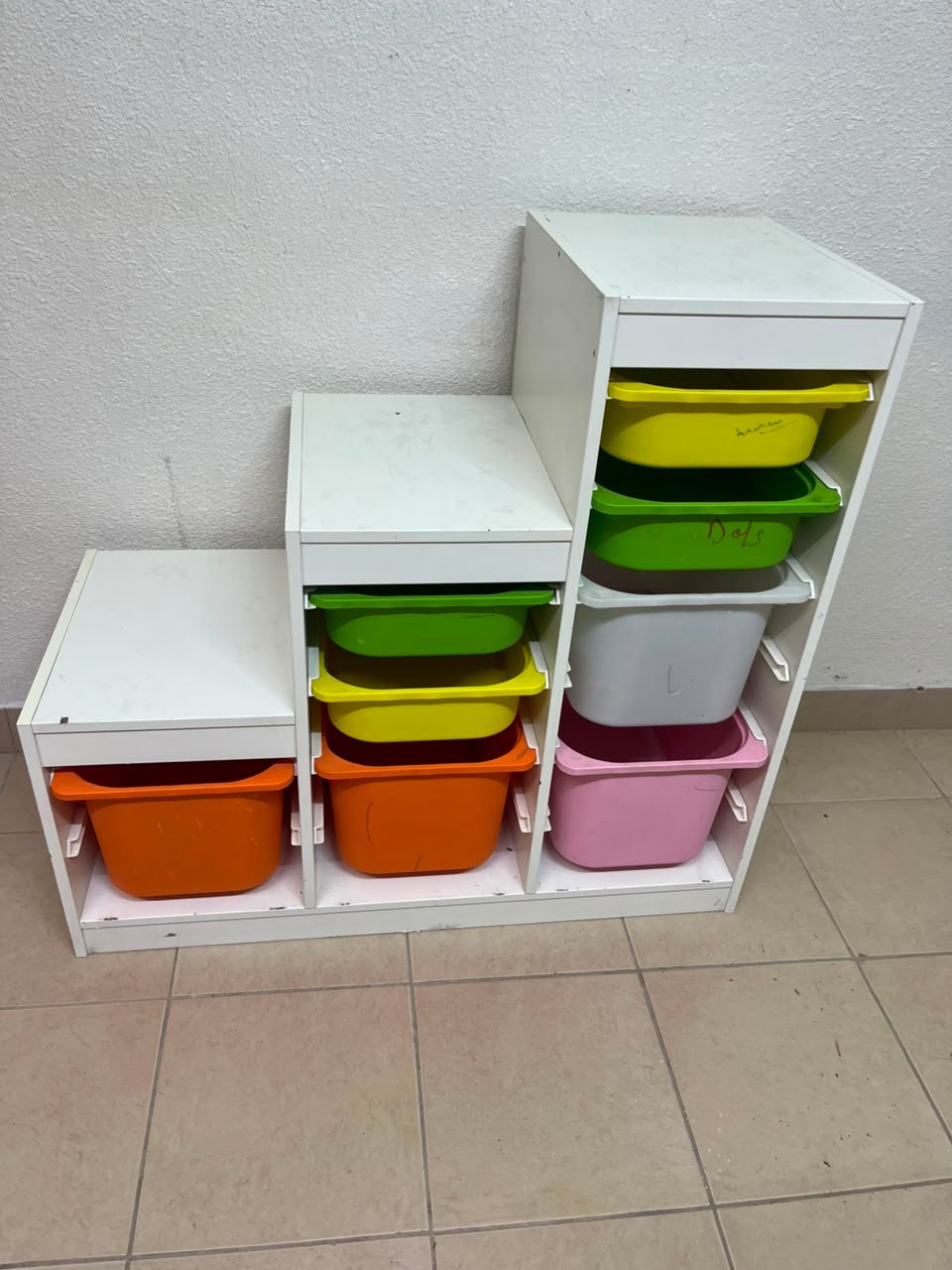 This TROFAST from IKEA is a children's toy storage unit designed with tiered levels for easy access, and features a white wooden frame. - Image 2