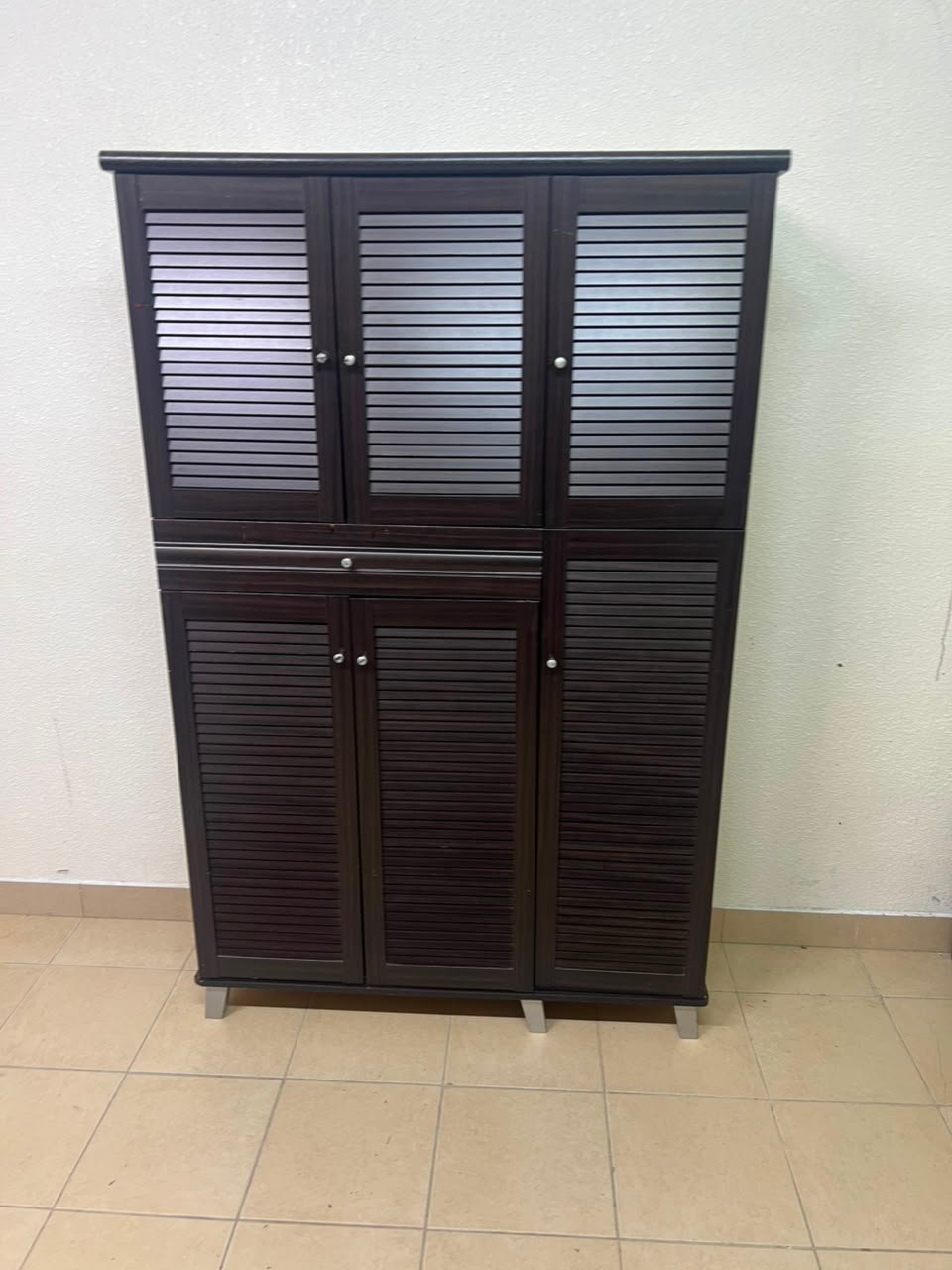 A shoe cabinet with 4 to 6 doors and one drawer in dark brown