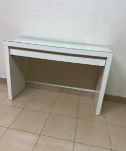 The MALM dressing table from IKEA in white features a durable, easy-to-clean glass top.