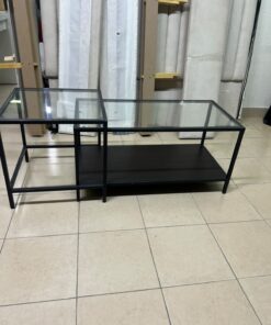 The IKEA VITTSJÖ nesting table set features black metal frames and glass tops.