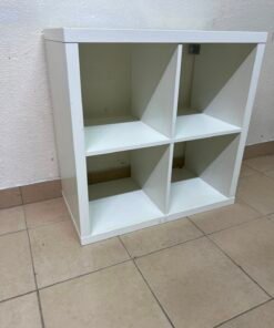The white IKEA Kalax unit features a minimalist design with six open sections.