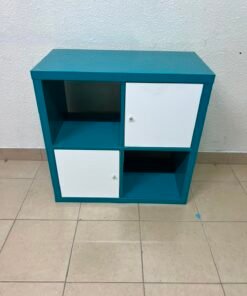 IKEA Kallax storage unit with 4 compartments in turquoise with two white doors.