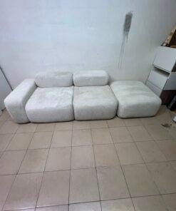 The Walls Nation "Marshmallow" patterned sofa in light white is made from comfortable bouclé fabric.