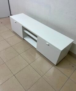 The glossy white IKEA BYÅS TV unit features a modern design and practical storage drawers.