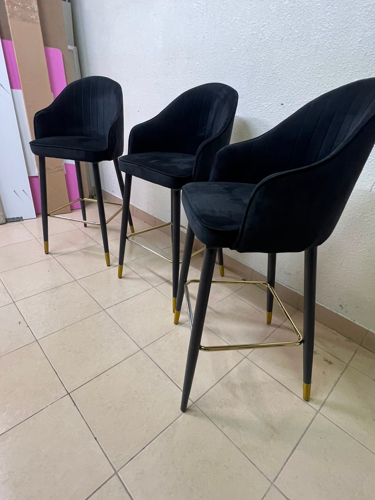 This black velvet bar stool from TUKA features a round design and black legs with gold accents. - Image 4