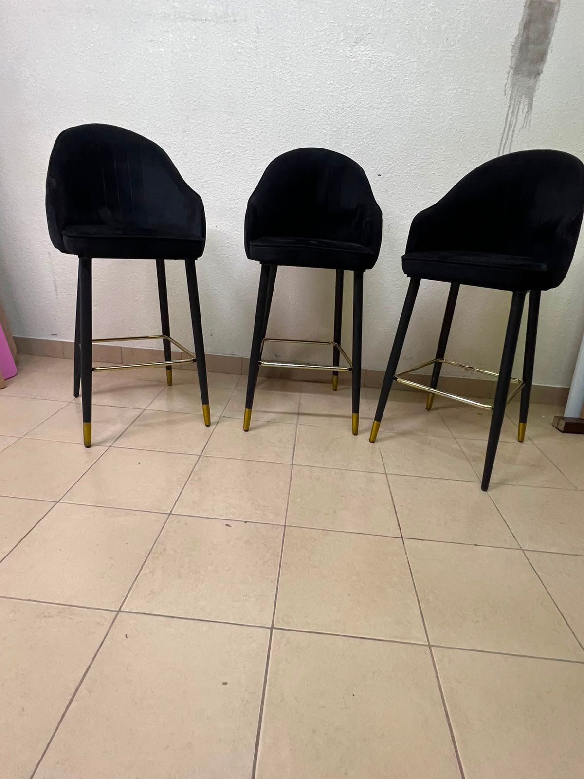This black velvet bar stool from TUKA features a round design and black legs with gold accents. - Image 6