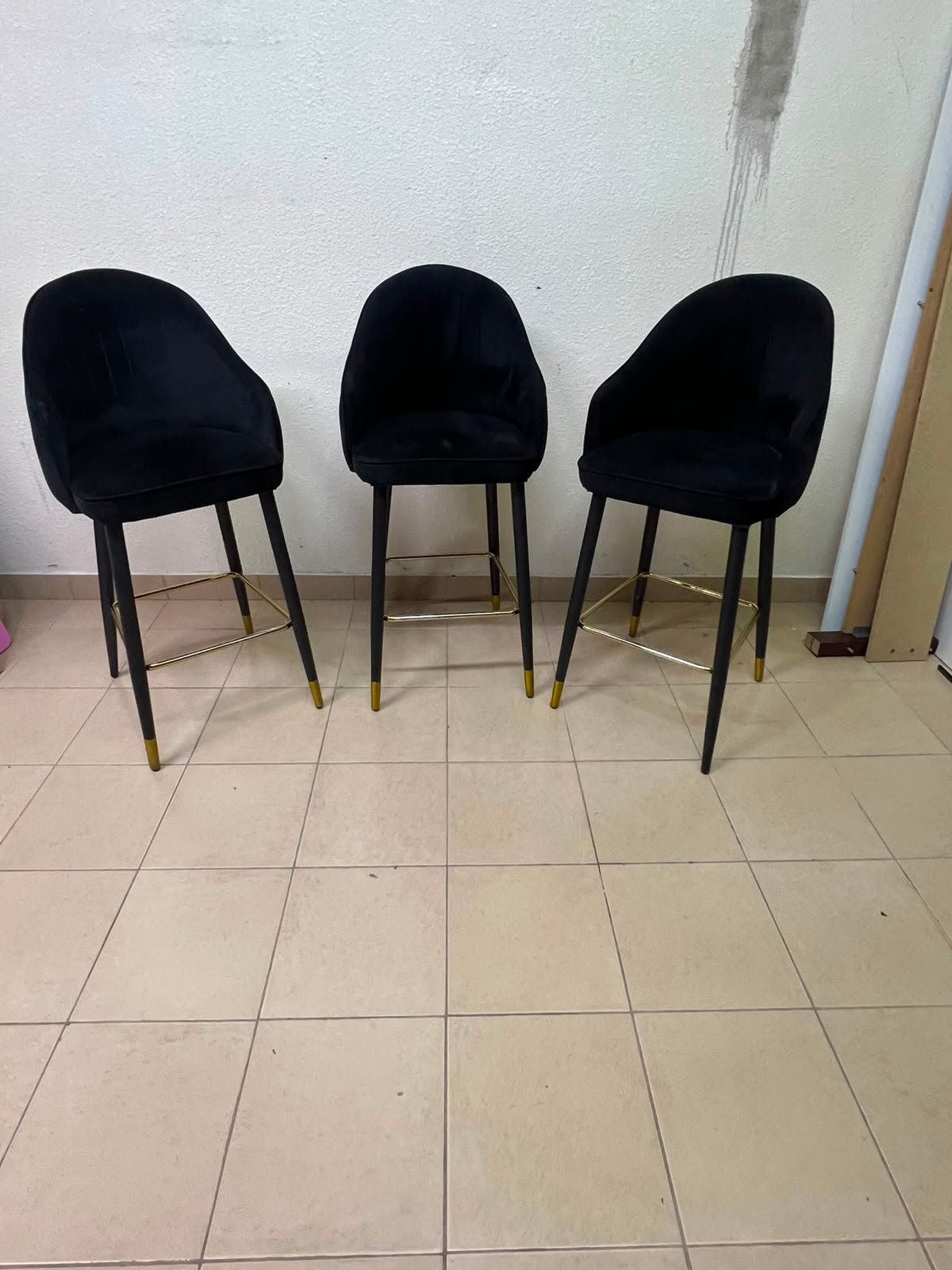 This black velvet bar stool from TUKA features a round design and black legs with gold accents. - Image 5