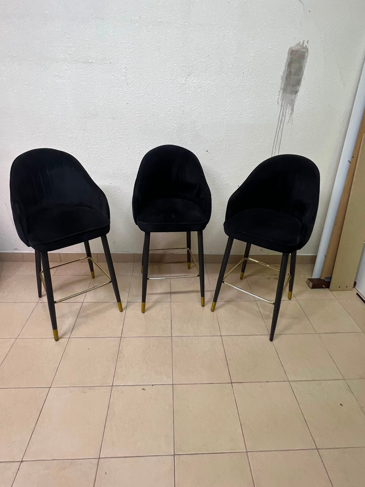 This black velvet bar stool from TUKA features a round design and black legs with gold accents. - Image 10