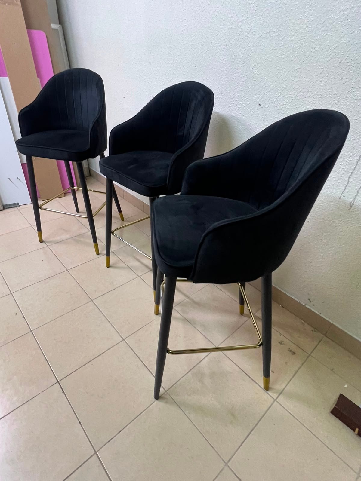 This black velvet bar stool from TUKA features a round design and black legs with gold accents. - Image 7