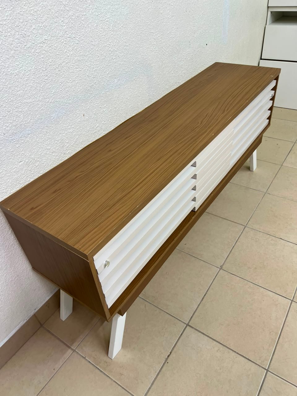The "Reflekt" TV unit from "Pan Emirates" features a brown wood design with white sliding doors for a modern touch. - Image 2