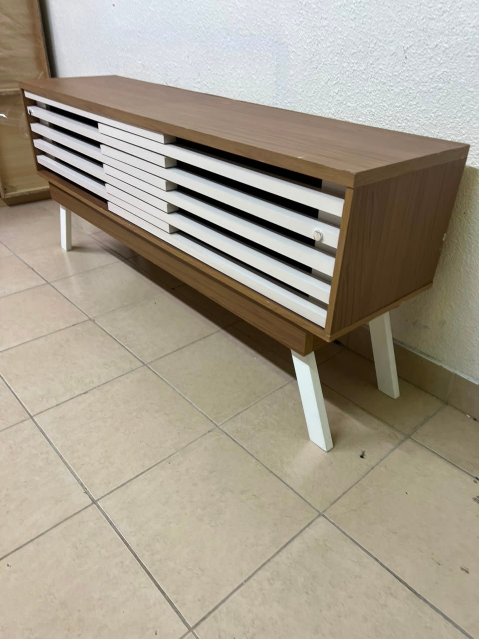 The "Reflekt" TV unit from "Pan Emirates" features a brown wood design with white sliding doors for a modern touch. - Image 13