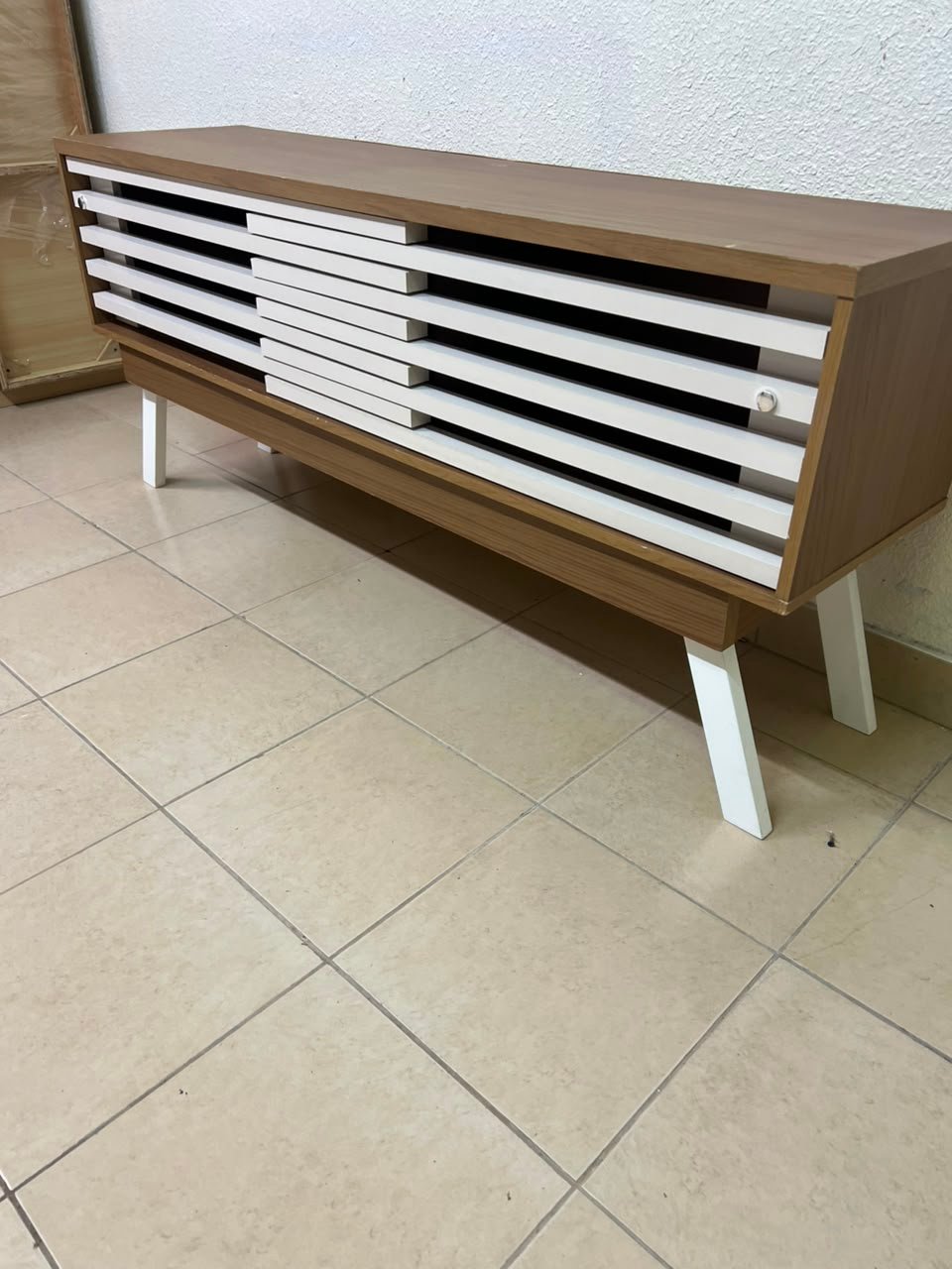 The "Reflekt" TV unit from "Pan Emirates" features a brown wood design with white sliding doors for a modern touch. - Image 7