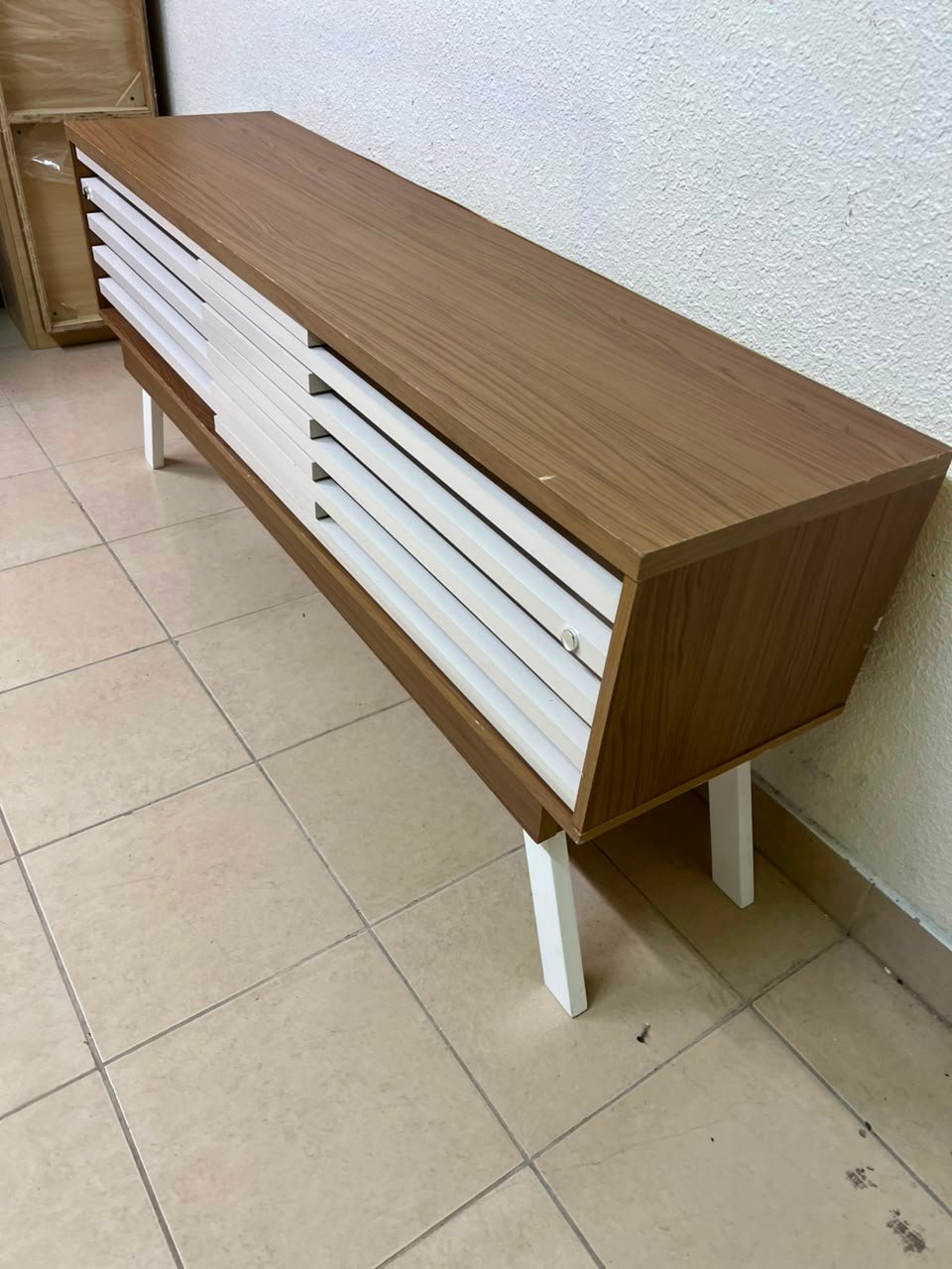 The "Reflekt" TV unit from "Pan Emirates" features a brown wood design with white sliding doors for a modern touch. - Image 3