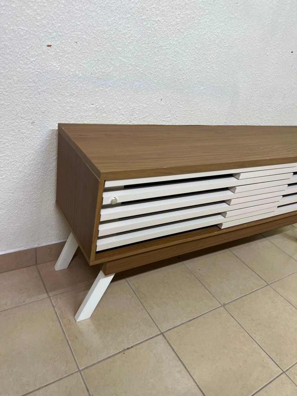 The "Reflekt" TV unit from "Pan Emirates" features a brown wood design with white sliding doors for a modern touch. - Image 9