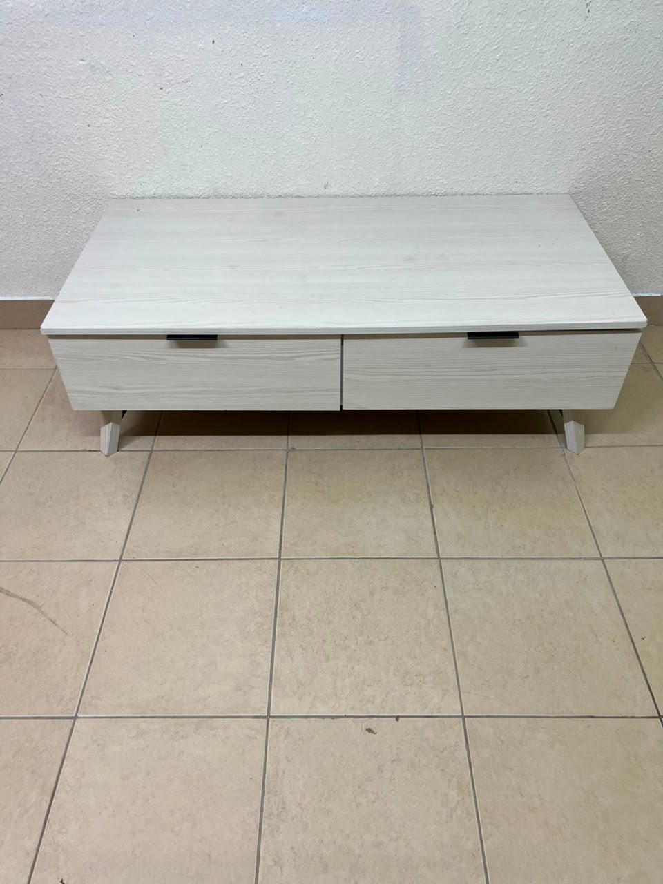 The white Wayne coffee table from Home Centre features two spacious drawers with black handles. - Image 3