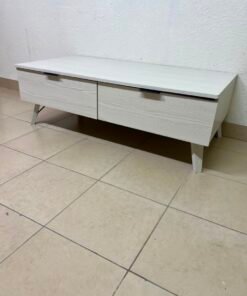 The white Wayne coffee table from Home Centre features two spacious drawers with black handles.