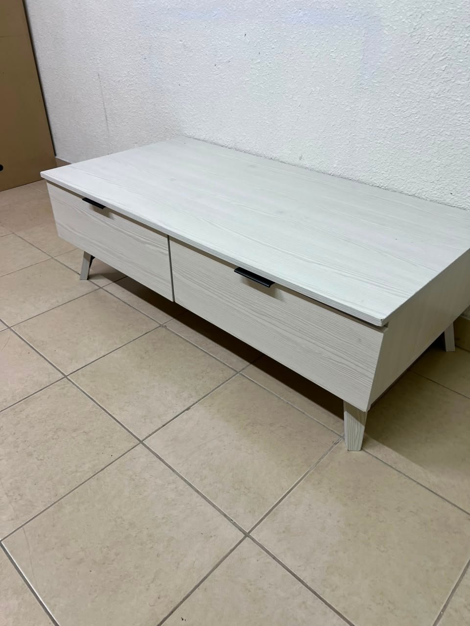 The white Wayne coffee table from Home Centre features two spacious drawers with black handles. - Image 6