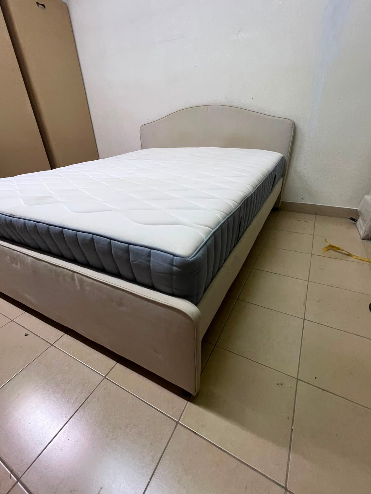 A bed from IKEA featuring a curved headboard and a beige upholstered base. - Image 12