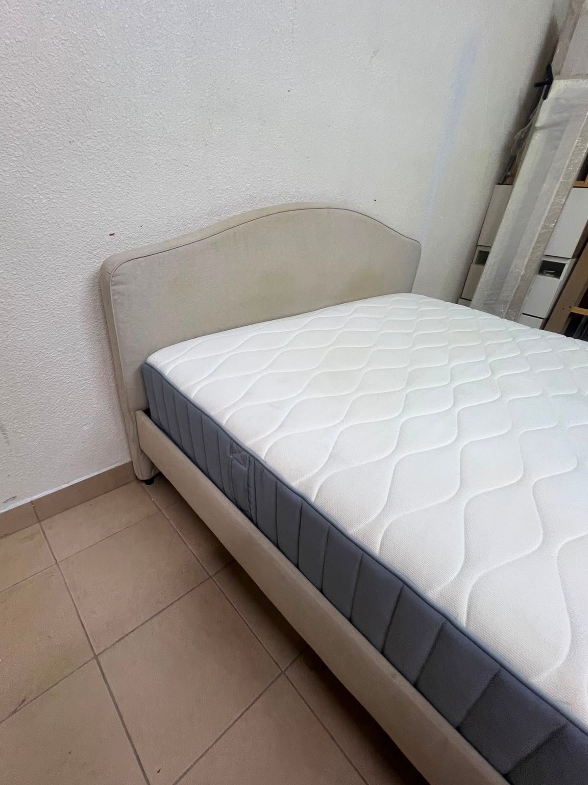 A bed from IKEA featuring a curved headboard and a beige upholstered base. - Image 3