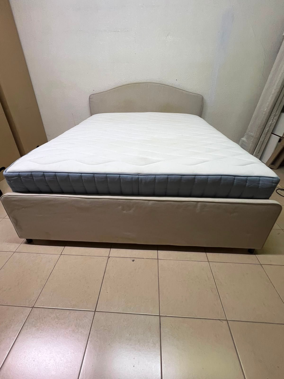 A bed from IKEA featuring a curved headboard and a beige upholstered base. - Image 7