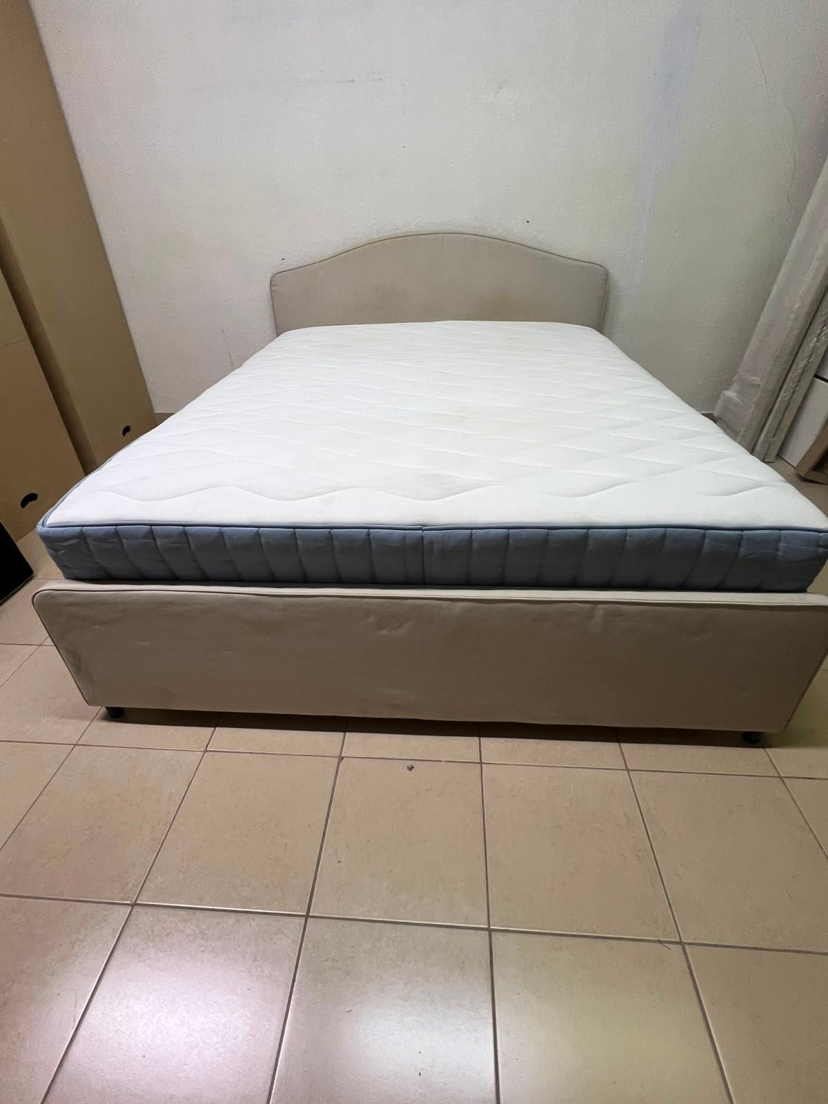 A bed from IKEA featuring a curved headboard and a beige upholstered base. - Image 9