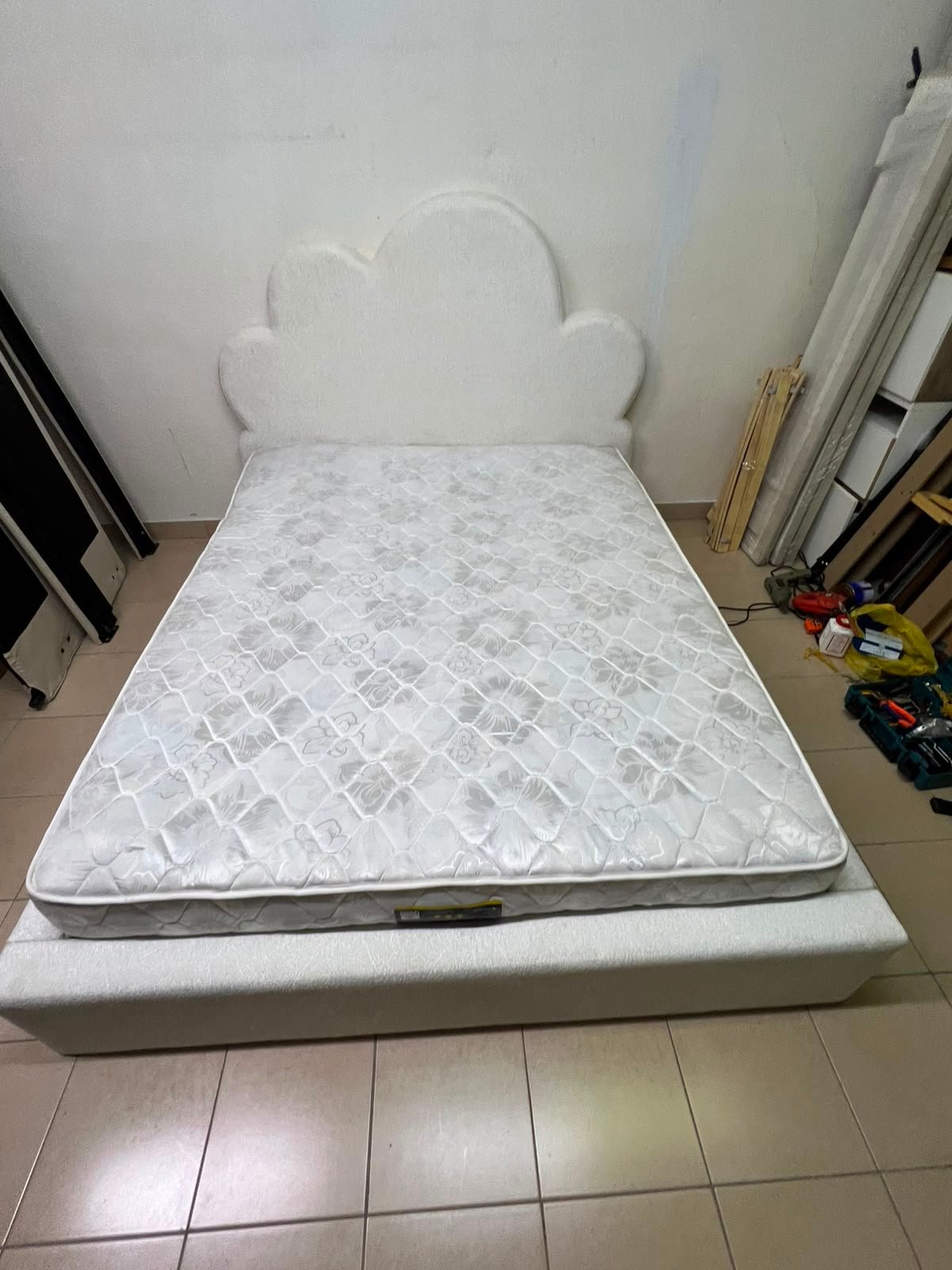 A fully upholstered white frame bed featuring a unique cloud-shaped headboard design. - Image 11