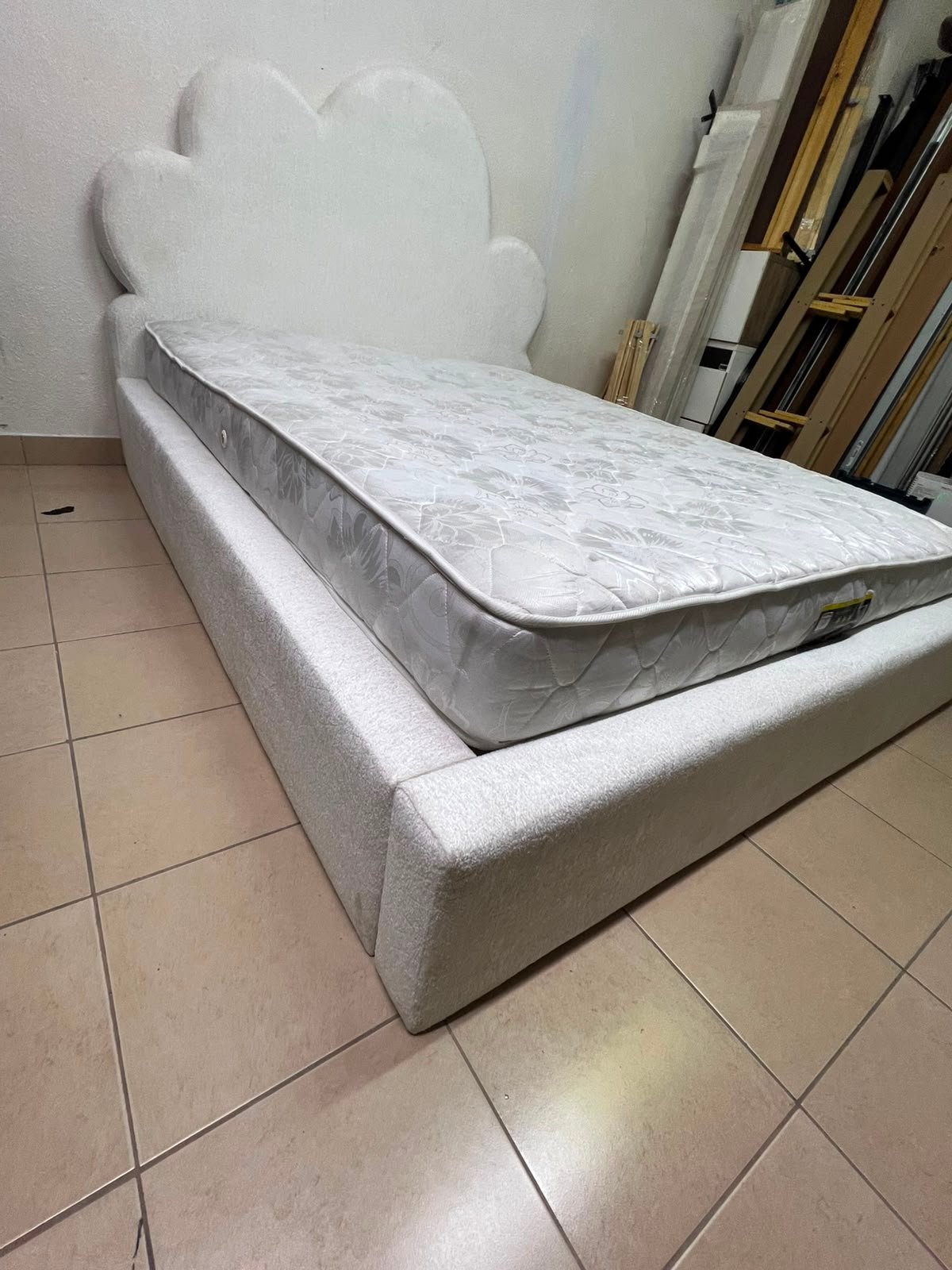 A fully upholstered white frame bed featuring a unique cloud-shaped headboard design. - Image 2