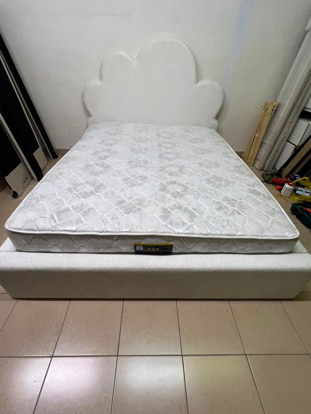 A fully upholstered white frame bed featuring a unique cloud-shaped headboard design. - Image 3
