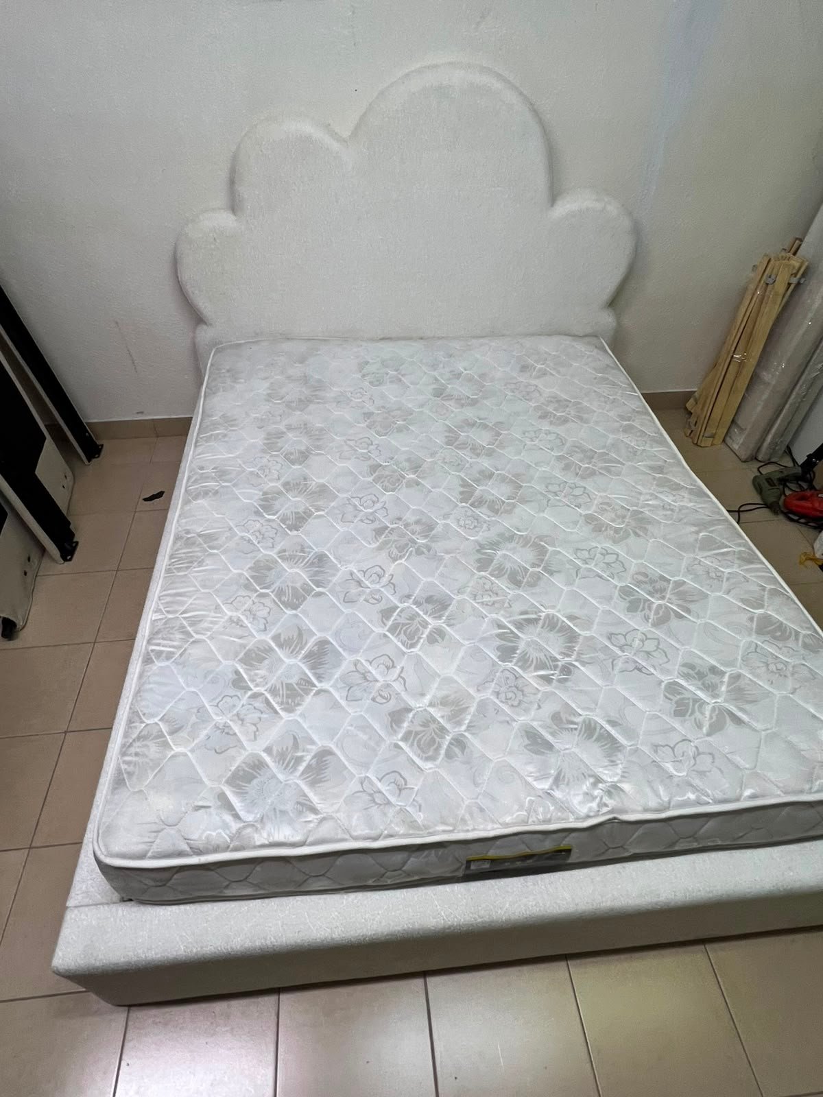 A fully upholstered white frame bed featuring a unique cloud-shaped headboard design. - Image 8