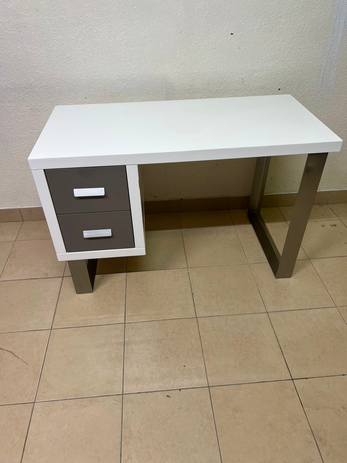 This modern white and gray desk from IKEA features a white top and sturdy metal legs.