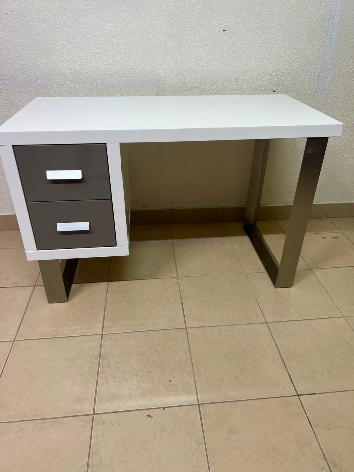 This modern white and gray desk from IKEA features a white top and sturdy metal legs. - Image 4