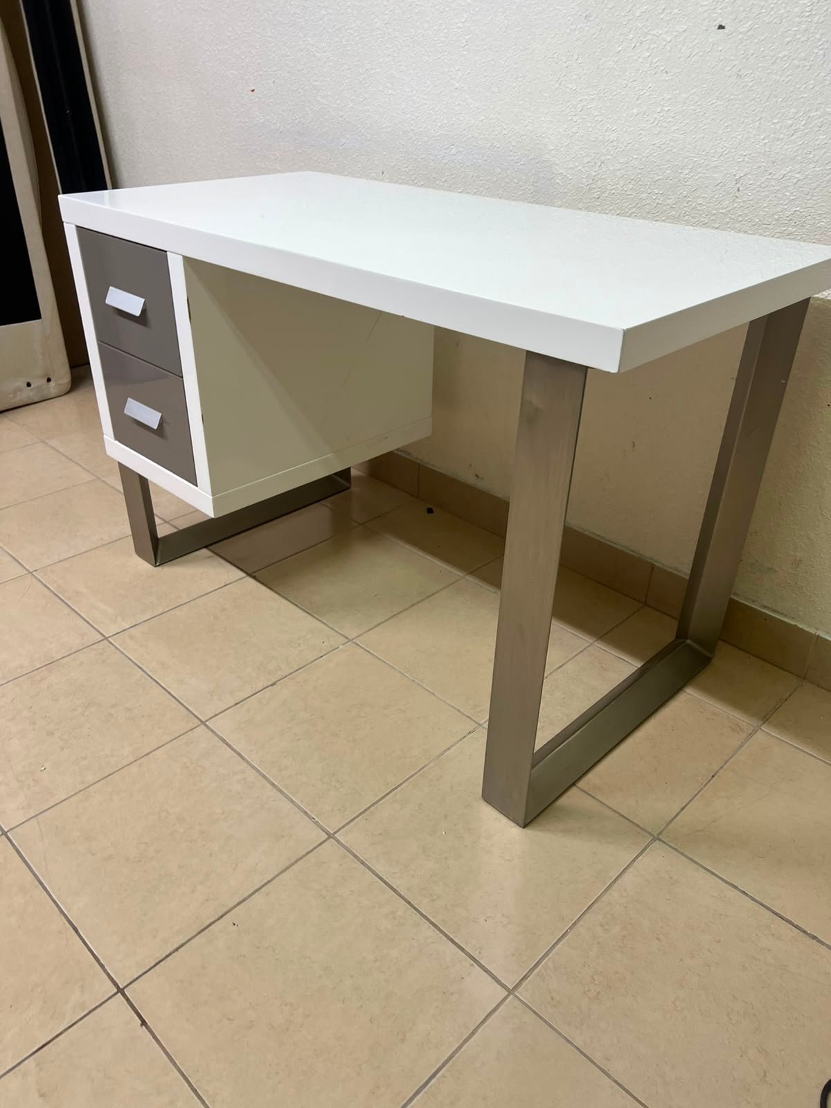 This modern white and gray desk from IKEA features a white top and sturdy metal legs. - Image 9