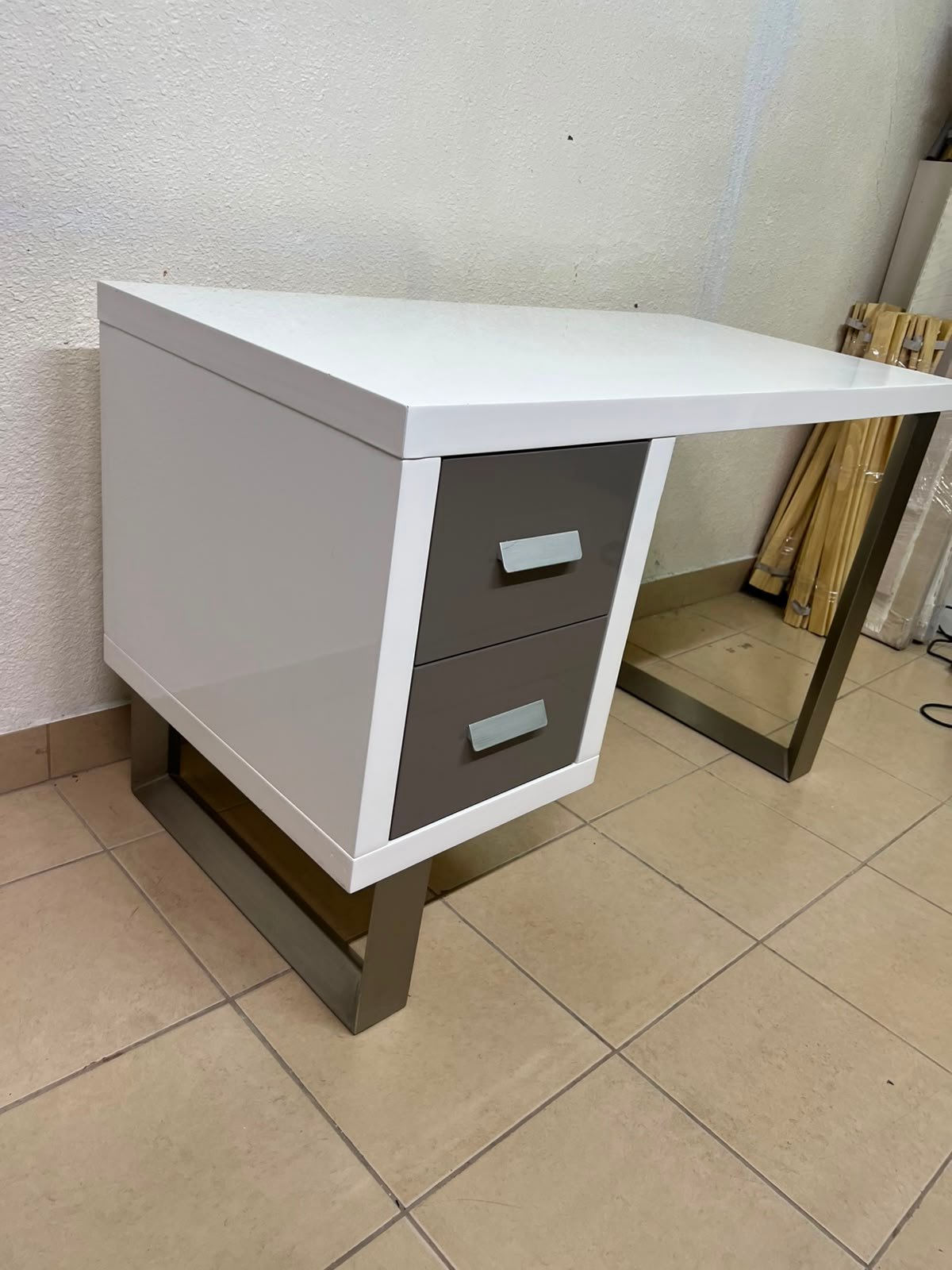 This modern white and gray desk from IKEA features a white top and sturdy metal legs. - Image 5