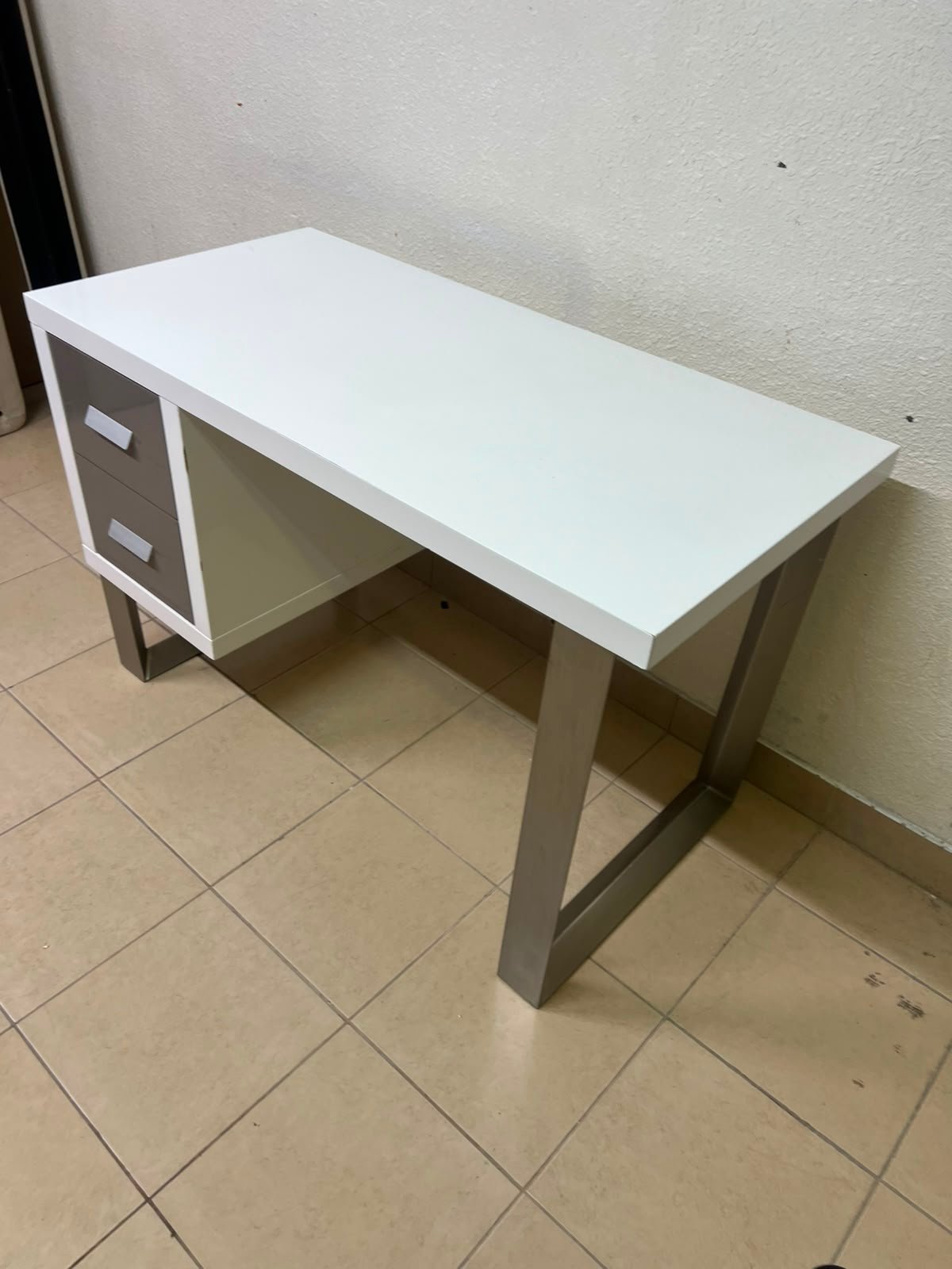 This modern white and gray desk from IKEA features a white top and sturdy metal legs. - Image 10