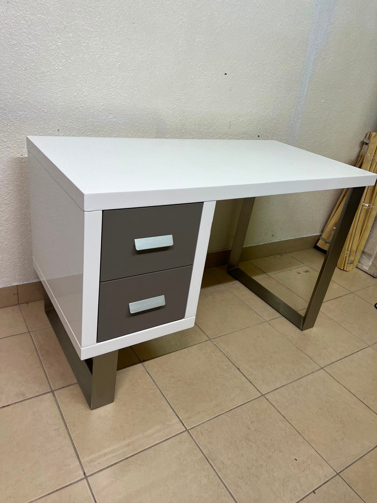 This modern white and gray desk from IKEA features a white top and sturdy metal legs. - Image 3
