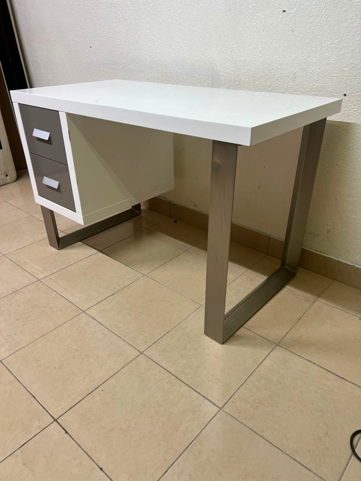 This modern white and gray desk from IKEA features a white top and sturdy metal legs. - Image 6