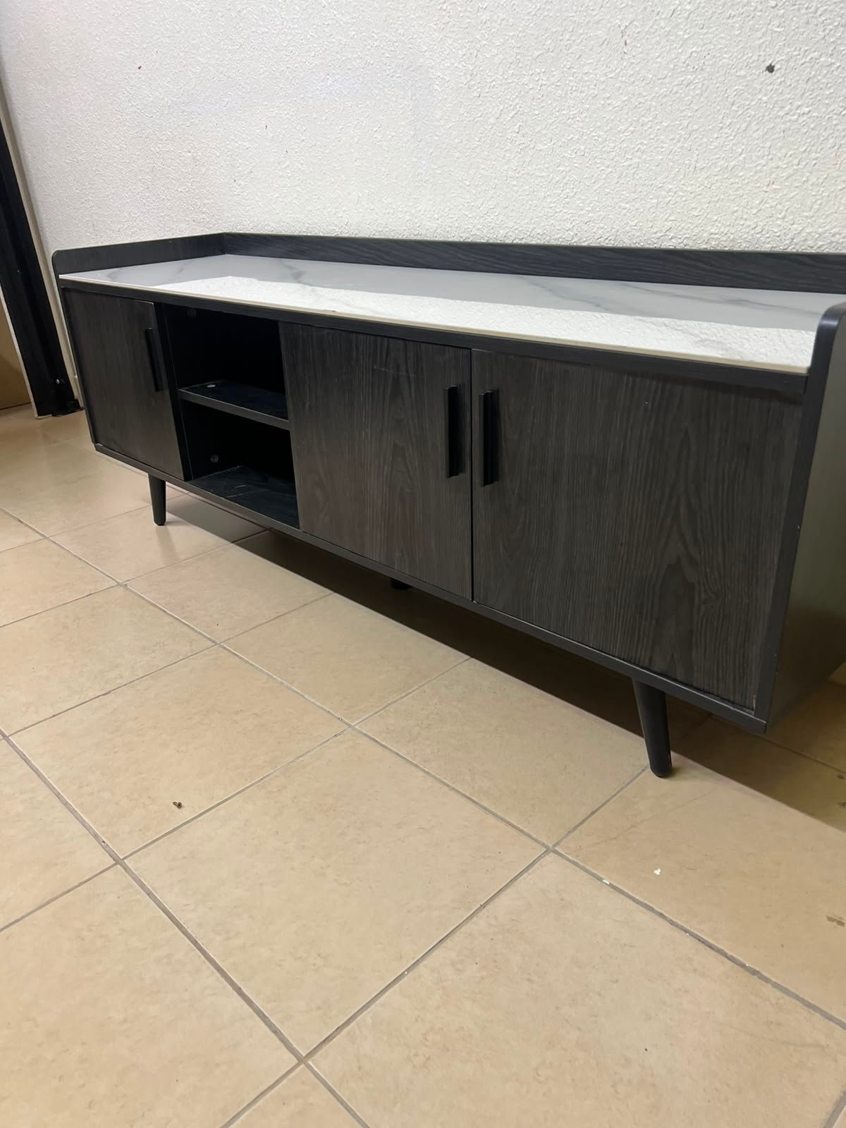 VEELOK brand TV unit with a modern design and black wooden legs