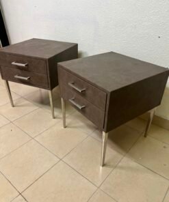 A brown bedside table with a leather or suede-like finish, featuring silver drawers and handles, similar to those found at Wayfair.
