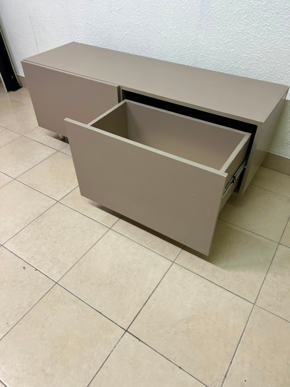 The TV cabinet features a calm beige color and a simple, modern design. - Image 9