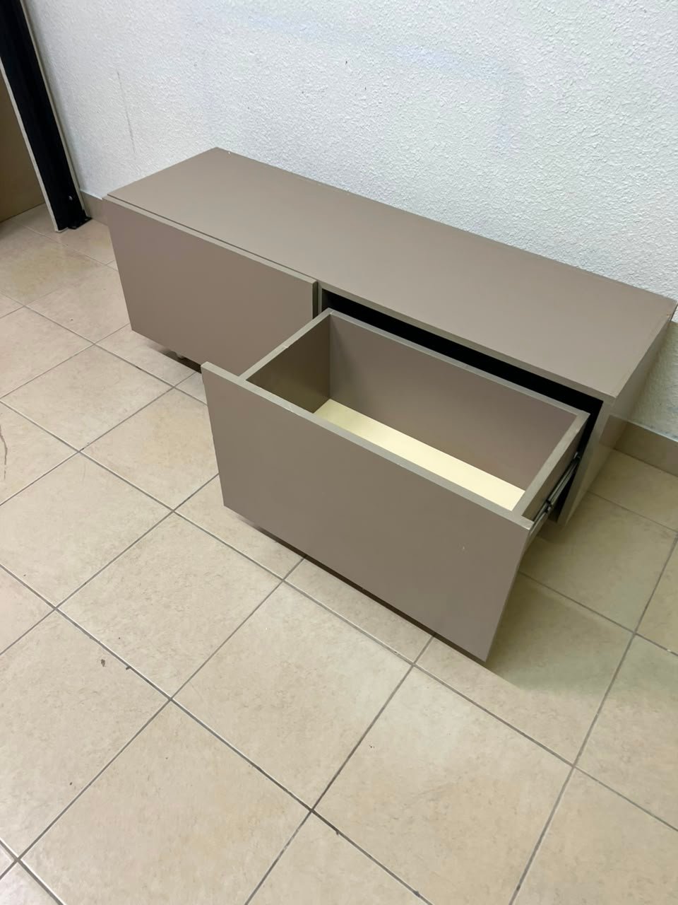 The TV cabinet features a calm beige color and a simple, modern design. - Image 6