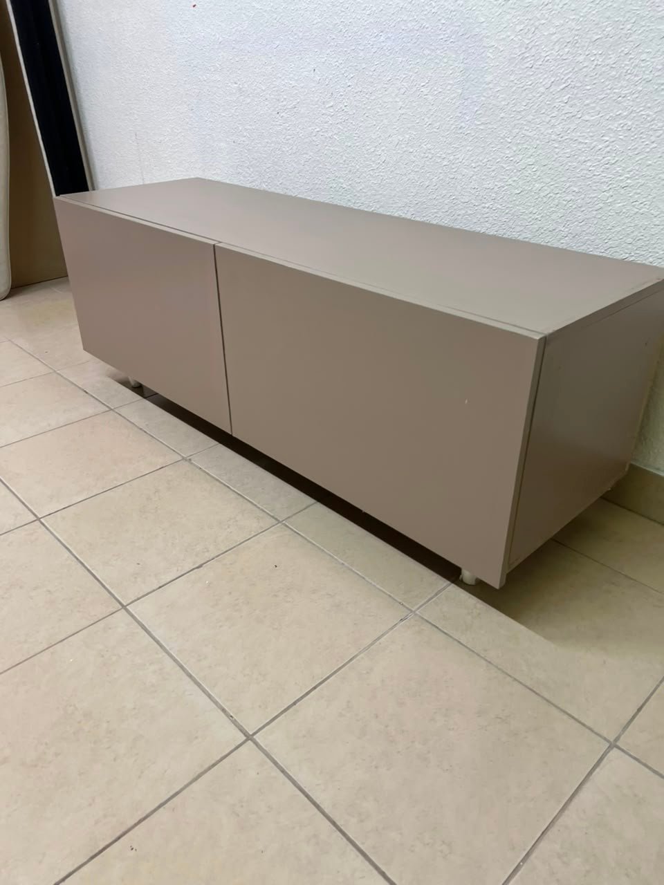 The TV cabinet features a calm beige color and a simple, modern design. - Image 10