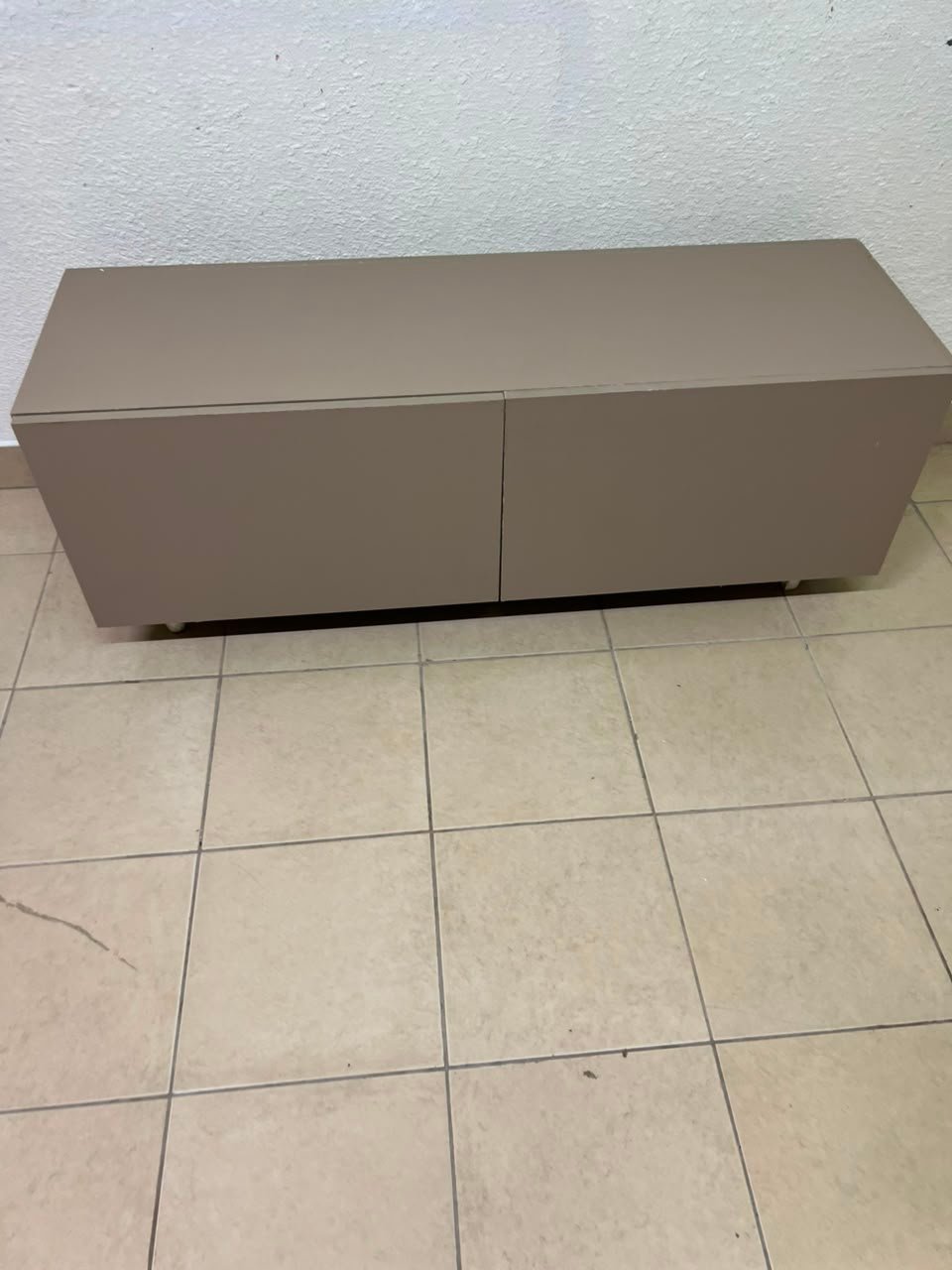 The TV cabinet features a calm beige color and a simple, modern design. - Image 11