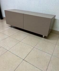 The TV cabinet features a calm beige color and a simple, modern design.