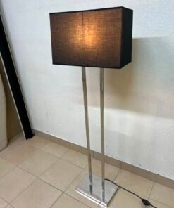 This modern floor lamp features a chrome-plated metal frame and a black fabric cover.