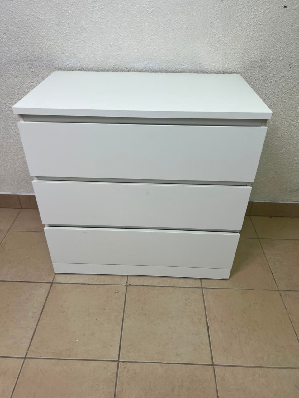 The white MALM chest of drawers from IKEA, which is characterized by its modern and simple design.