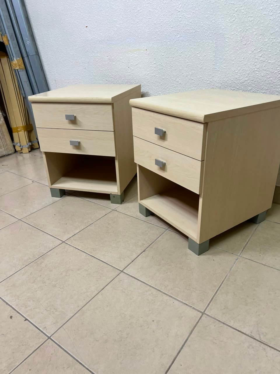 A set of two modern bedside tables in a light wood color with two drawers and open storage space. - Image 5