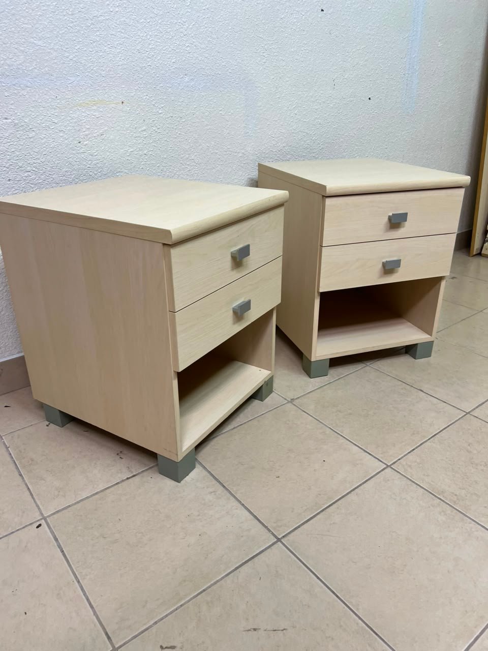 A set of two modern bedside tables in a light wood color with two drawers and open storage space. - Image 4