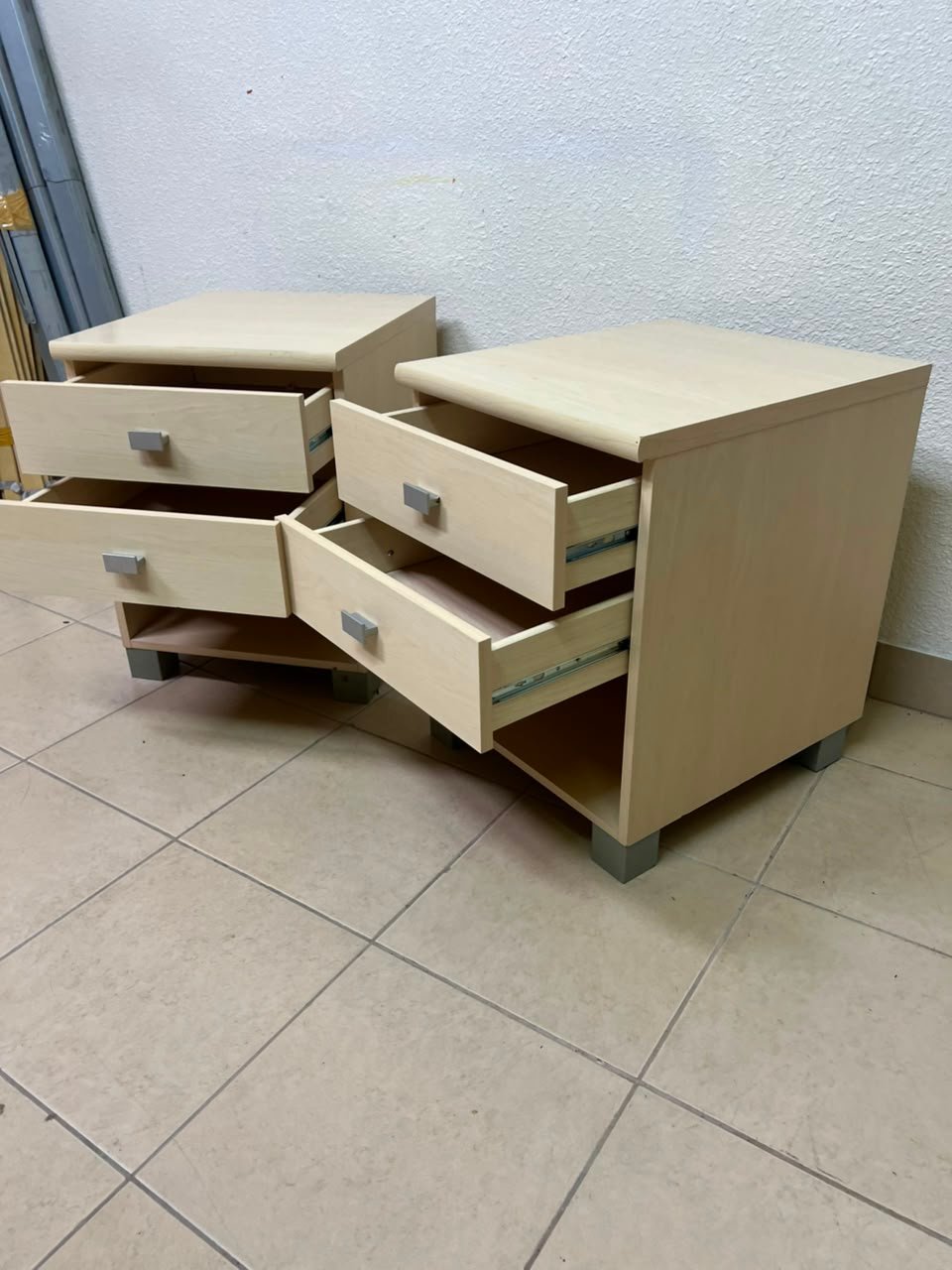 A set of two modern bedside tables in a light wood color with two drawers and open storage space. - Image 6